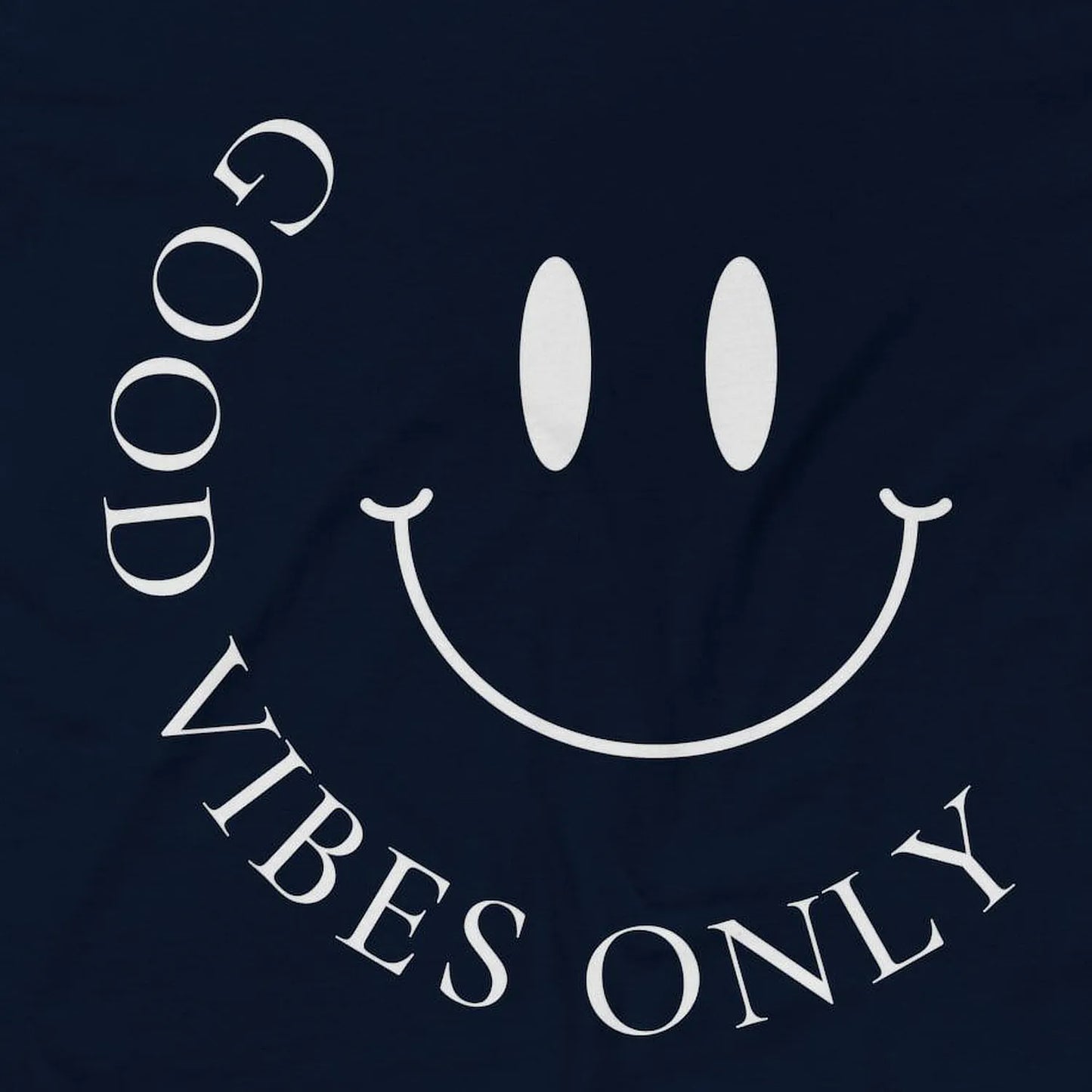 Close-up of navy AS Colour 5001 tee with white minimalist “Good Vibes Only” smiley front print.