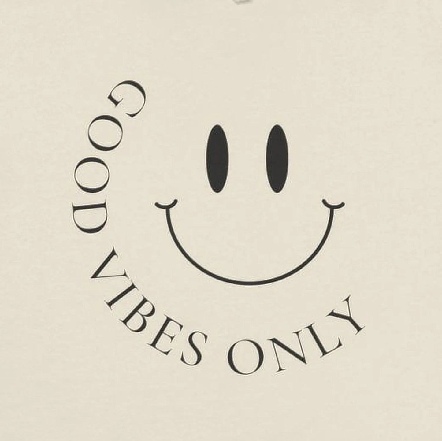 Close-up of minimalist “Good Vibes Only” smiley face front print.