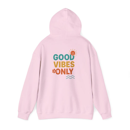 Back of light pink hoodie featuring stacked “Good Vibes Only” text with sun, flower, and wave icons in vibrant retro colors